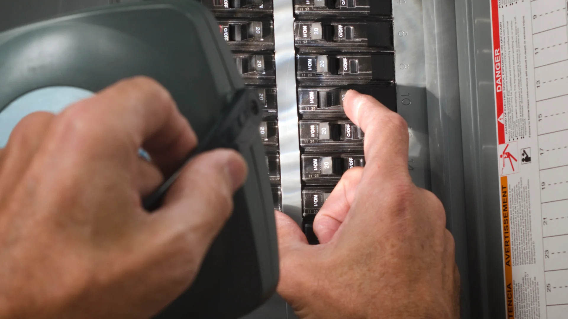 photo of electrician working in panel